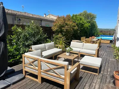 a deck with chairs and tables and a pool at Spacious Villa With Pool Near Carcassonne in Soupex