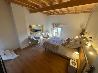a bedroom with a bed and a living room at Spacious Villa With Pool Near Carcassonne in Soupex