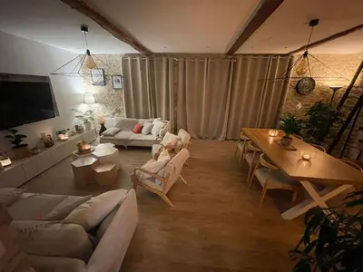 a living room with a couch and a table at Spacious Villa With Pool Near Carcassonne in Soupex