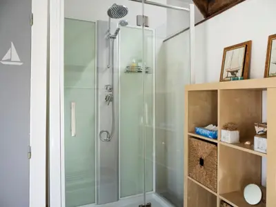 a shower with a glass door in a bathroom at D'une maison à l'autre in Cépie