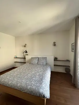 a bedroom with a large bed with two pillows at L'Escapade Narbonnaise in Narbonne