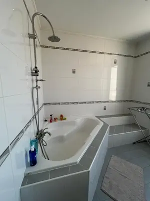 a white bath tub in a bathroom with a shower at L'Escapade Narbonnaise in Narbonne