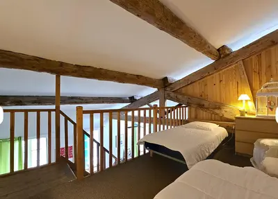 a bedroom with two beds and a balcony at La Maison Bleue de Sigean - Loft 1 in Sigean