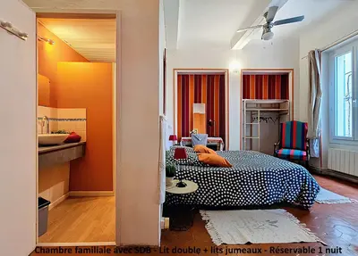 a bedroom with a bed and a sink in it at La Maison Bleue de Sigean - Loft 1 in Sigean