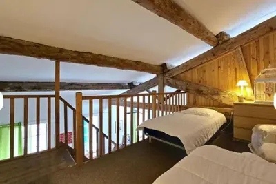 a bedroom with two beds and a balcony at La Maison Bleue de Sigean - Loft 2 in Sigean