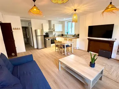 a living room with a blue couch and a table at Saint-Germain T2 Residence Apartment in Carcassonne