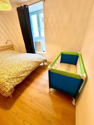 a bedroom with a bed with a blue and green drawer at Saint-Germain T2 Residence Apartment in Carcassonne