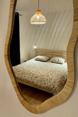 a bedroom with a bed in a round mirror at Saint-Germain T2 Residence Apartment in Carcassonne