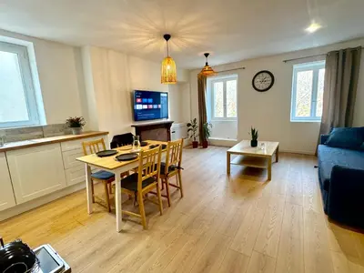 a living room with a table and a couch at Saint-Germain T2 Residence Apartment in Carcassonne