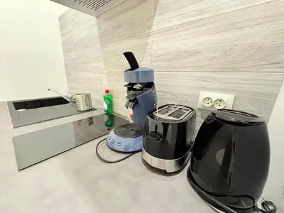 a coffee maker sitting on a counter in a kitchen at L'Écrin Signature, Studio élégant en centre-ville in Pamiers