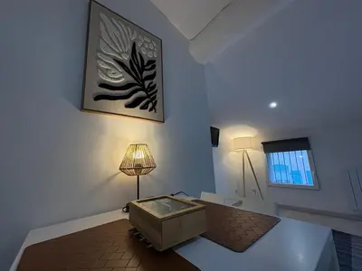 a room with a table with a lamp and a window at L'Écrin Signature, Studio élégant en centre-ville in Pamiers