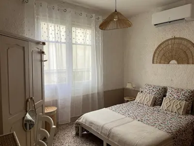 a small bedroom with a bed and a window at Appartement bord de mer in Port-la-Nouvelle
