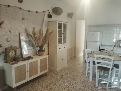 a kitchen and dining room with a table and a dining room at Appartement bord de mer in Port-la-Nouvelle
