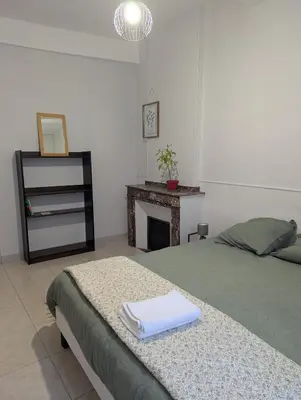 a bedroom with a bed with two towels on it at Cosy Bastide 4 personnes in Carcassonne