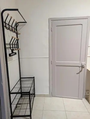 a closet with a white door and a shelf at Cosy Bastide 4 personnes in Carcassonne