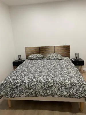 a bedroom with a bed and two night stands at Studio rénové pour 2 personnes - centre ville in Carcassonne