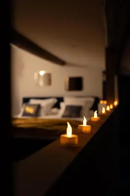 a row of candles on a table in a living room at l'écrin du désir in Capestang