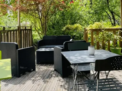 a patio with a table and chairs on a deck at Chalet avec Terrasse à Camon - API-1-52-902 in Camon