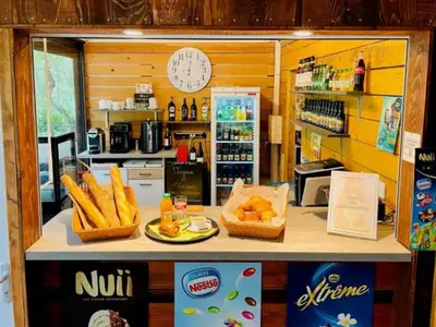 a kitchen with a counter with bread and a refrigerator at Chalet avec Terrasse pour 5 personnes - API-1-52-905 in Camon