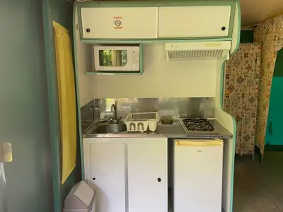 a small kitchen with a sink and a stove at Bungalow 3 Pièces avec Terrasse - API-1-52-888 in Camon