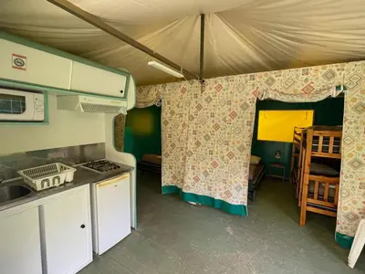 a caravan with a kitchen and a tent at Bungalow 3 Pièces avec Terrasse - API-1-52-888 in Camon