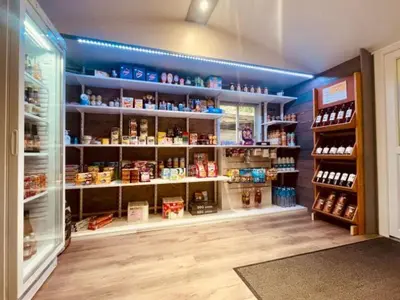 a store aisle with a lot of products on shelves at Mobil-home confortable avec terrasse au calme - API-1-52-915 in Camon
