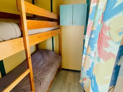 a bunk bed room with two bunk beds and a ladder at Chalet cosy avec terrasse pour 4 personnes - API-1-52-919 in Camon
