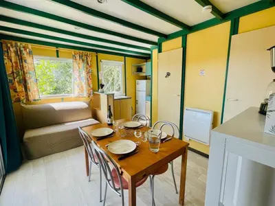 a kitchen and dining room with a table and chairs at Chalet cosy avec terrasse pour 4 personnes - API-1-52-919 in Camon