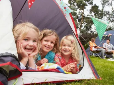 two little girls are sitting in a tent at Chalet cosy avec terrasse pour 4 personnes - API-1-52-919 in Camon