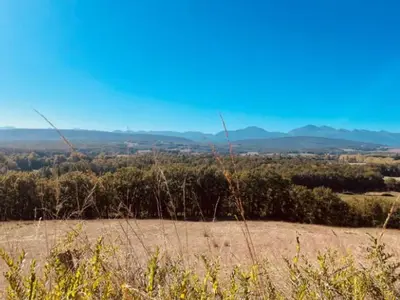 a view of a field with mountains in the background at Chalet 18m², Terrasse sur Pilotis, 4 Personnes - API-1-52-927 in Camon