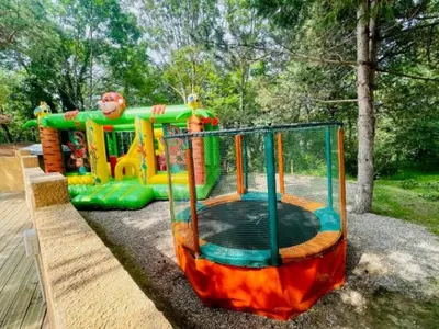 a playground with a play equipment in a park at Chalet 18m², Terrasse sur Pilotis, 4 Personnes - API-1-52-927 in Camon