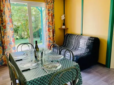 a table with chairs and a couch in a room at Chalet Confort 6 Pers - Terrasse - API-1-52-1032 in Camon