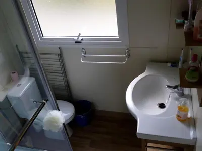 a bathroom with a sink and a toilet and a window at Chalet confortable 4 pers avec terrasse - API-1-52-1139 in Camon