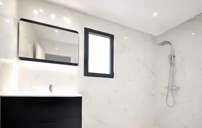 a bathroom with a sink and a mirror and a shower at Villa Avec Piscine Privée in Portel-des-Corbières