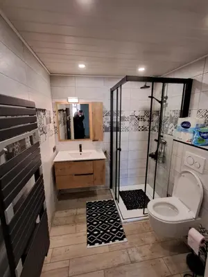 a bathroom with a shower and a toilet and a sink at location maison gruissan in Gruissan