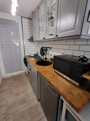a kitchen with a counter top with a microwave at location maison gruissan in Gruissan