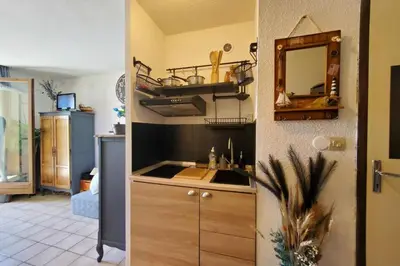 a kitchen with a sink and a mirror at Studio Horizon - Parking Commerces Plage in Port-la-Nouvelle