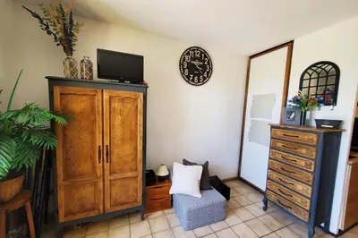 a room with a dresser and a tv on a wall at Studio Horizon - Parking Commerces Plage in Port-la-Nouvelle