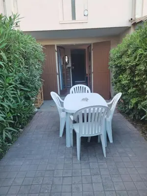a white table and chairs on a patio at Studio Horizon - Parking Commerces Plage in Port-la-Nouvelle