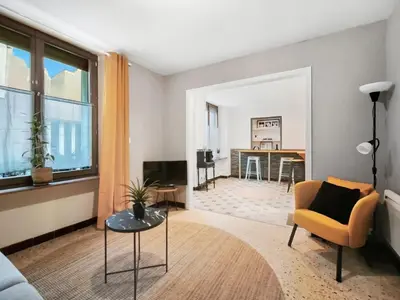 a living room with a couch and a table at Suite Privative Design au Cœur de Trèbes in Trèbes
