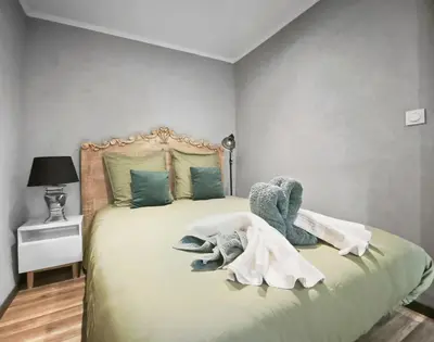 a bedroom with a bed with stuffed animals on it at Suite Privative Design au Cœur de Trèbes in Trèbes