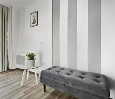 a living room with a couch and a table at Suite Privative Design au Cœur de Trèbes in Trèbes