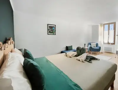 a bedroom with a large bed in a room at Suite Privative Design au Cœur de Trèbes in Trèbes