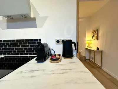 a kitchen counter with a blender on a counter top at Charmant deux pièces en plein centre-ville de NARBONNE in Narbonne