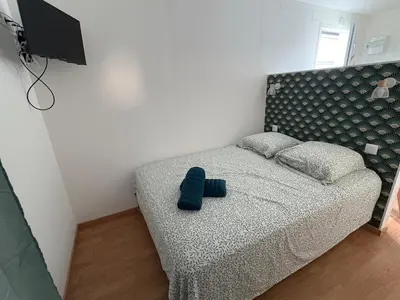 a bedroom with a bed with a blue object on it at Charles de Gaulle lll - Independent Garden in Castres