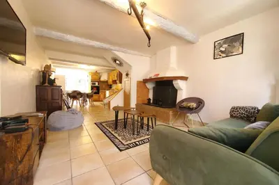 a living room with a couch and a stove at La Tomette 3 chambres avec joli patio in Sigean