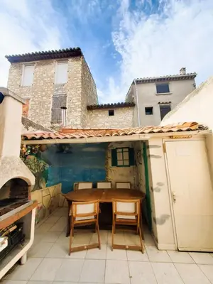 a patio with a table and chairs on a roof at La Tomette 3 chambres avec joli patio in Sigean
