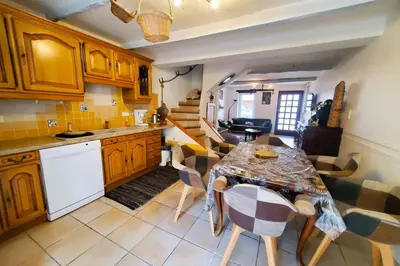 a kitchen with a table and chairs in a room at La Tomette 3 chambres avec joli patio in Sigean