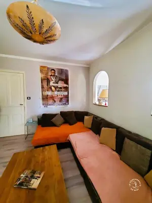 a living room with a couch and a table at Gîte Le Mississipi in Narbonne