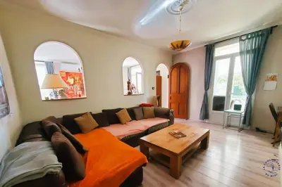a living room with a couch and a table at Gîte Le Mississipi in Narbonne